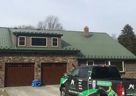 contractor truck outside of house in need of metal roof replacement