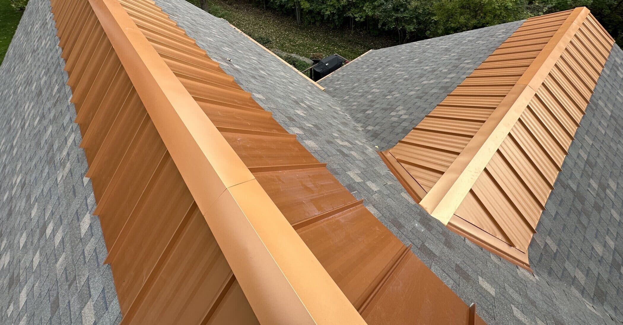 Copper metal ridge cap installed by SMR Home Pros