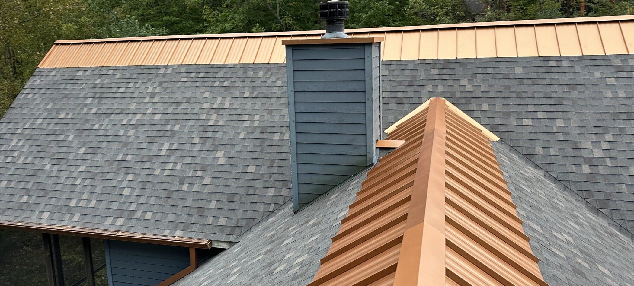 Shingle roof with copper metal ridge cap installed by SMR Home Pros