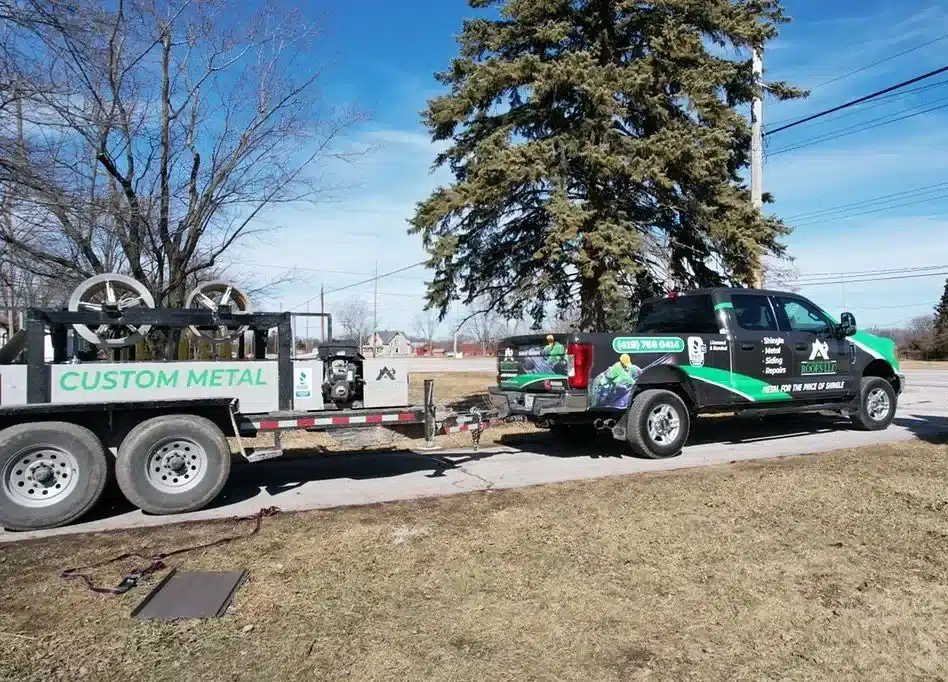 Showcasing SMR Home Pros' custom metal forming machine and a wrapped truck in shingle and metal roofs branding.