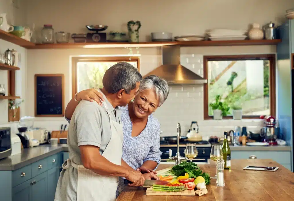 Happy couple at home under new roof after financing their project.