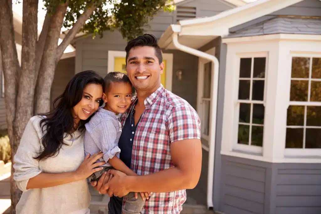 happy family moving into new home with new gutters