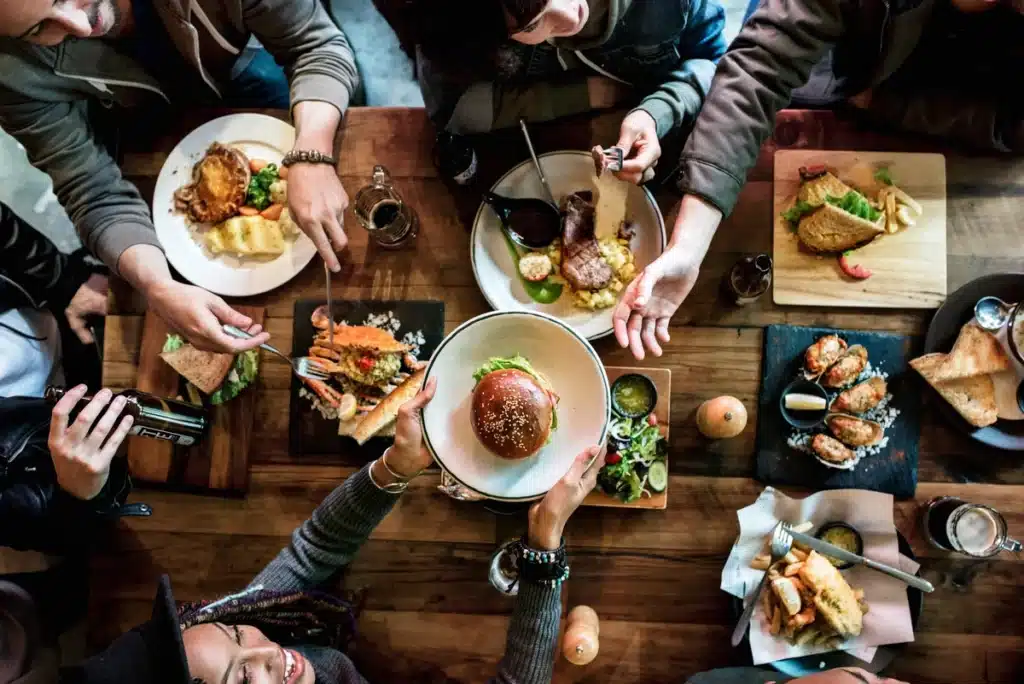 friends gathered around a table eating in a toledo restaurant