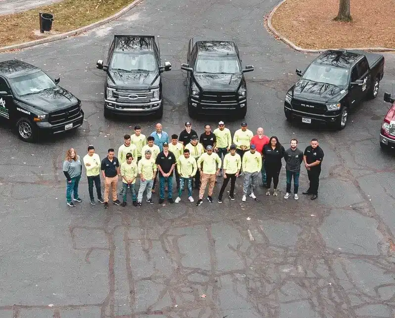 shingle & metal roofing group picture on the street