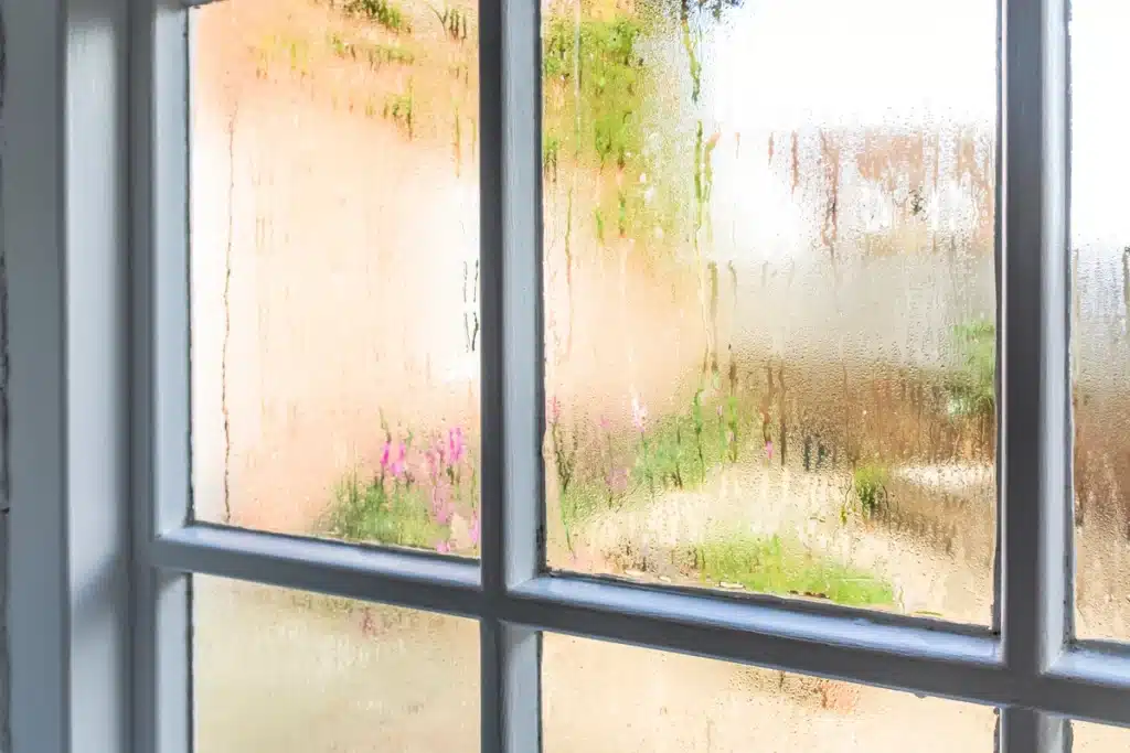 close up of older types of windows with condensation 
