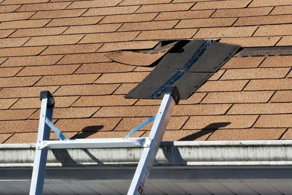 close up of asphalt roof missing shingles in need of repair