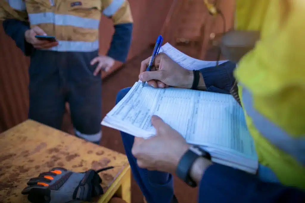 workers as a group checking the construction permit