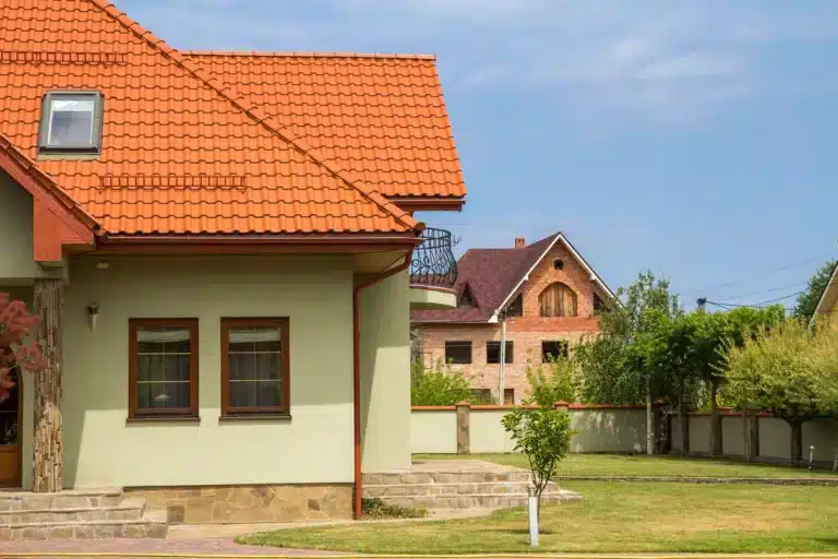 roof inspected house with clay tile roof and yard