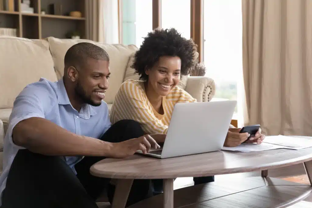 young black couple researching the cost of metal roof