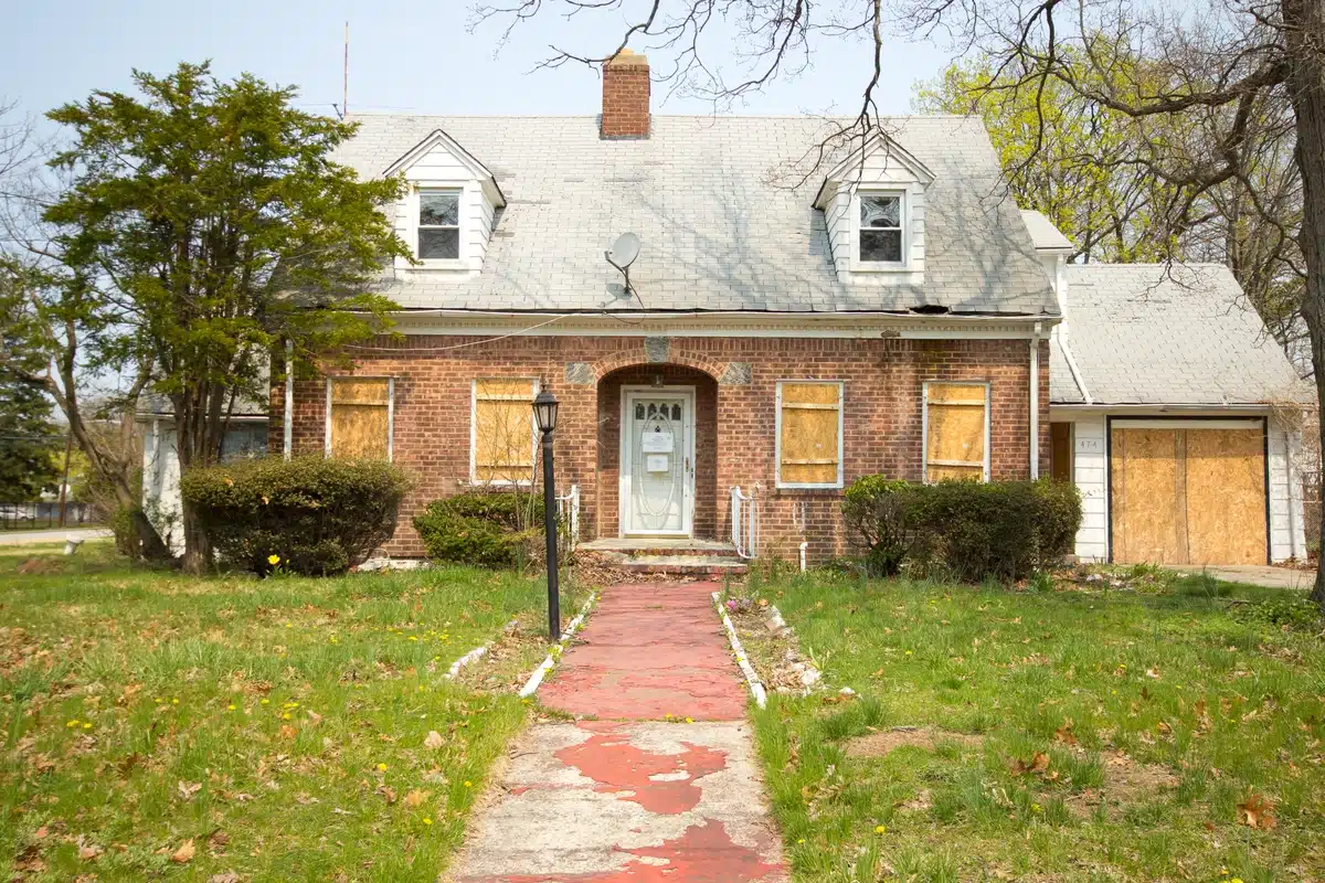 aging house with damaged roof and walk way