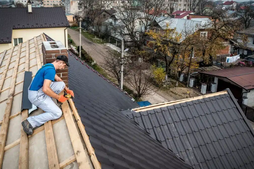 professional worker installing metal tiles 