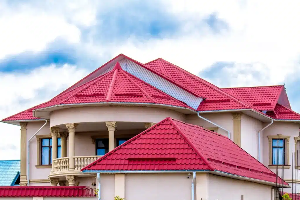 luxury house with red metal tile roof and balcony