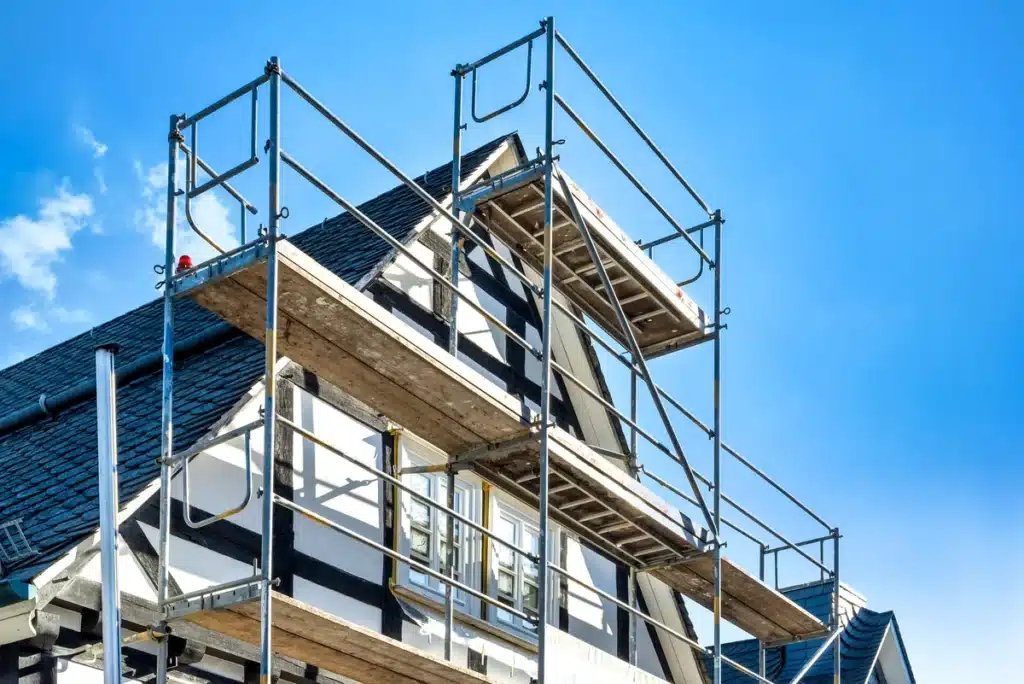timbered house getting repaired on damaged roof