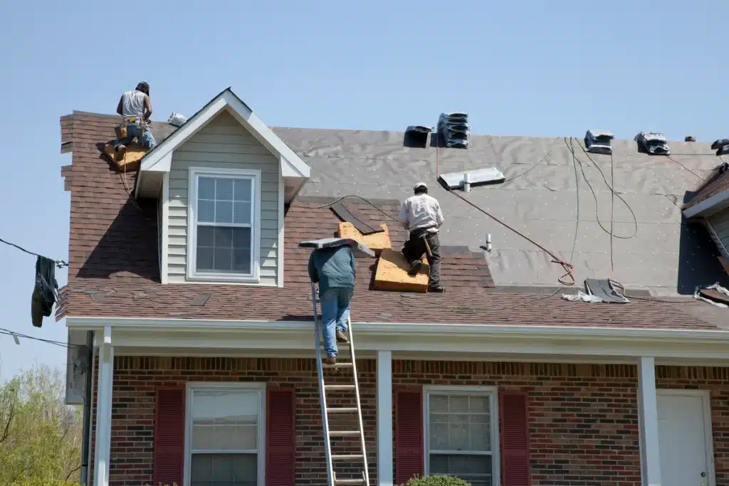 construction crew in the process of replacing roof