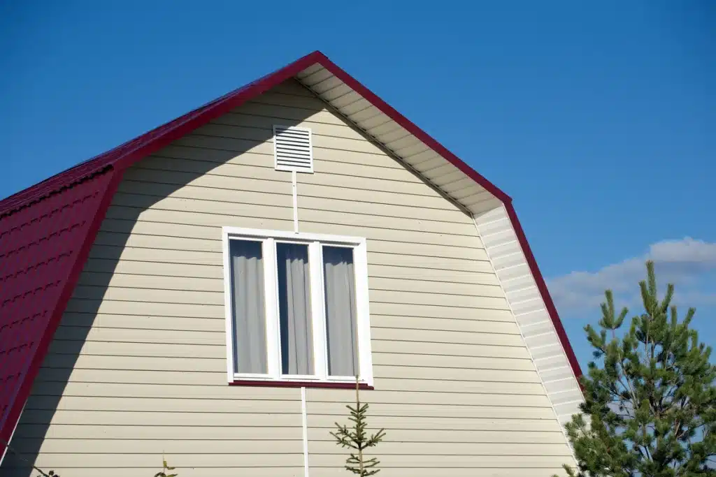 large house with metal roof and vinyl siding