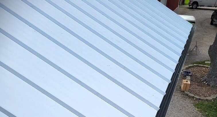 Edge of metal roof featuring black gutter guards installed by SMR Home Pros during a metal roof replacement project.