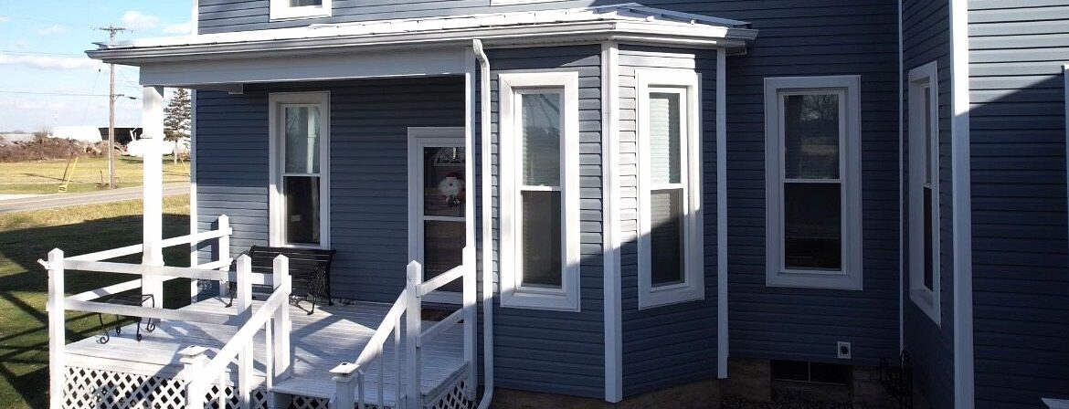 Custom windows paired with new vinyl siding installed by SMR Home Pros