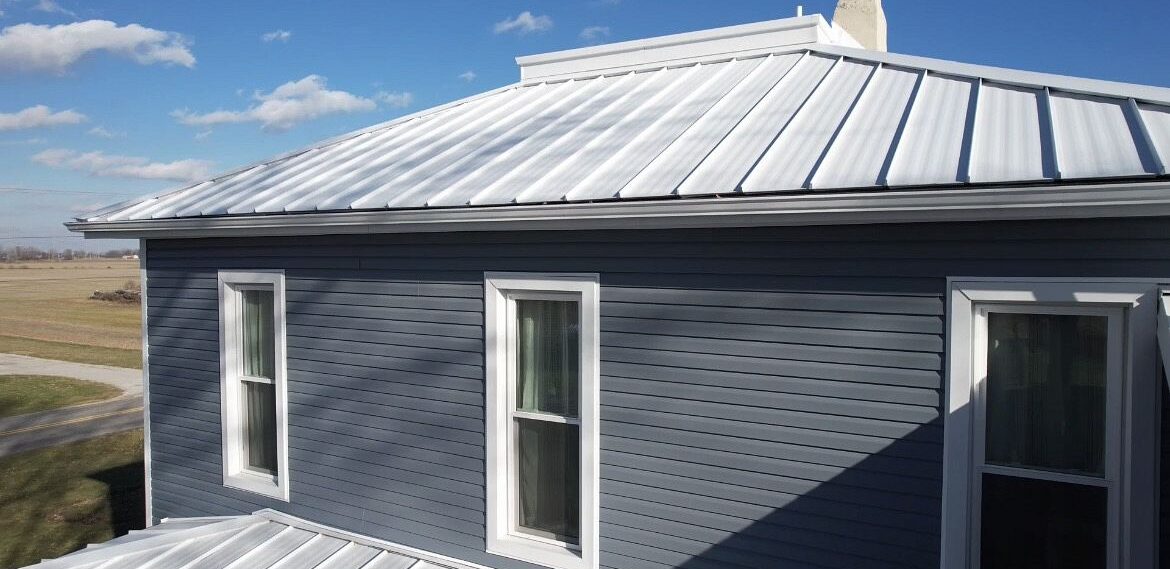Home improvement work featuring Polar white standing steam metal, custom Polaris windows and blue Polaris vinyl siding installed by SMR Home Pros