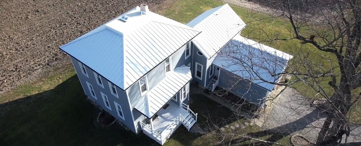 Farm house featuring brand new metal roof, custom windows and vinyl siding completed by SMR Home Pros