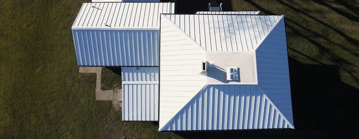 Above a brand new, expertly installed Polar white standing seam metal roof installed by SMR Home Pros