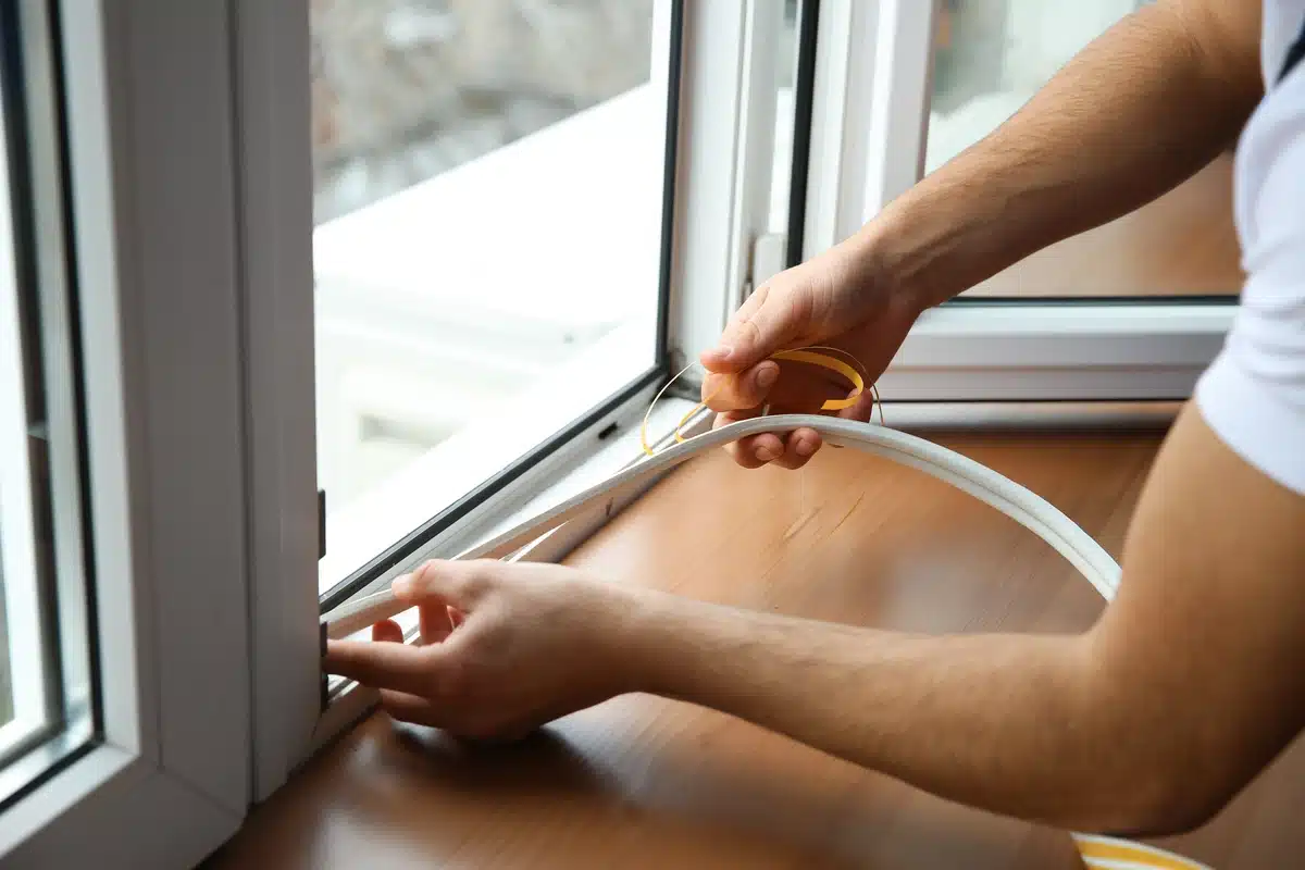 man-sealing-window