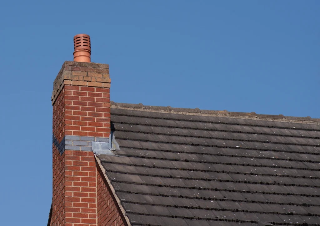 chimney flashing repair-chimney on the side of the house with metal flashing