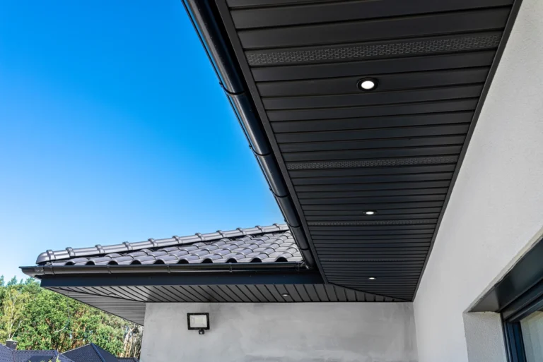 eaves of a house-black eaves on stone colored home exterior