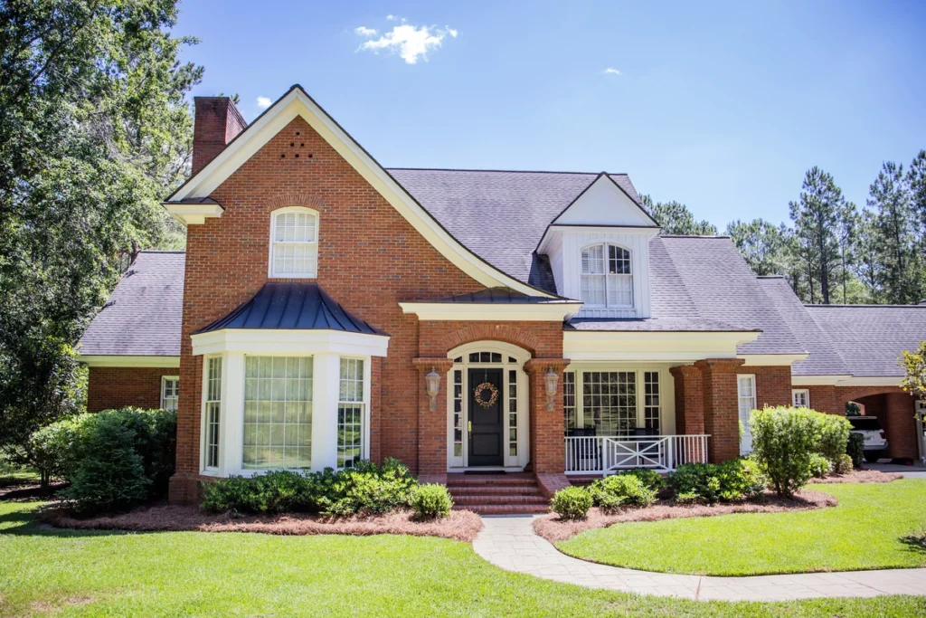 house and roof color combinations-red brick house dark roof