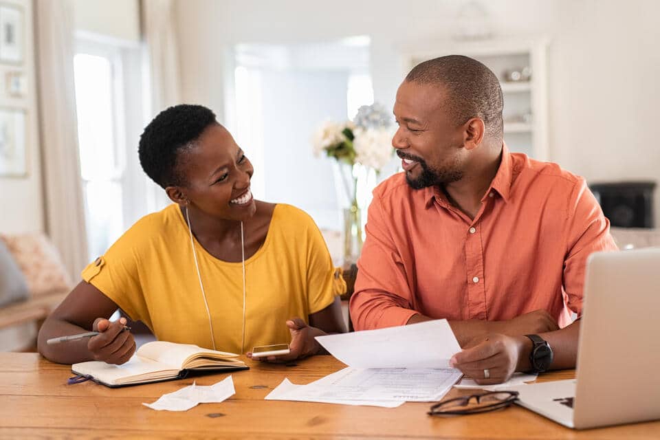 how to pay for a new roof-a couple going over their finances together