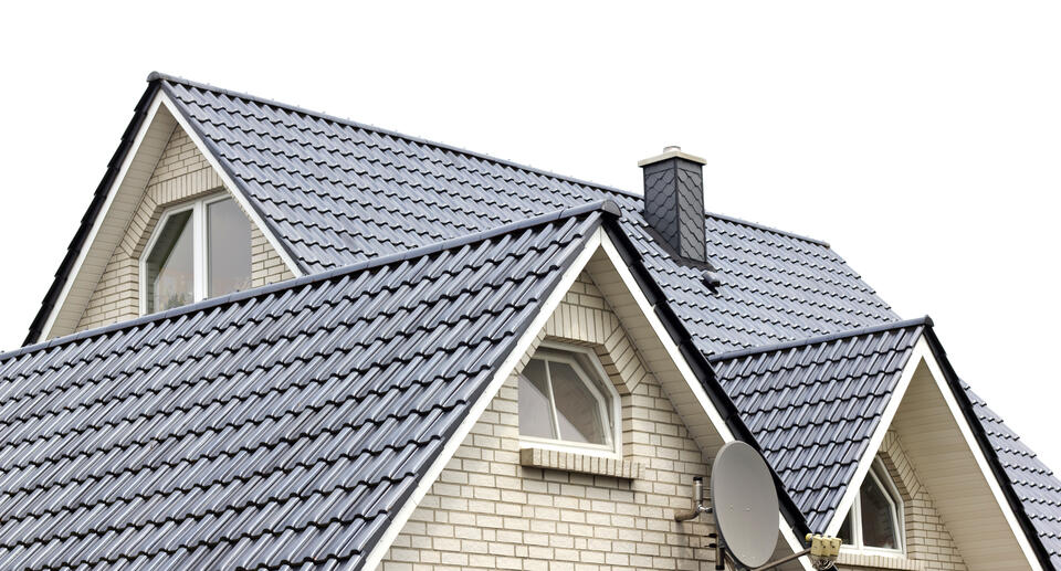 how to pay for a new roof-white brick house with new black metal shingle roofing