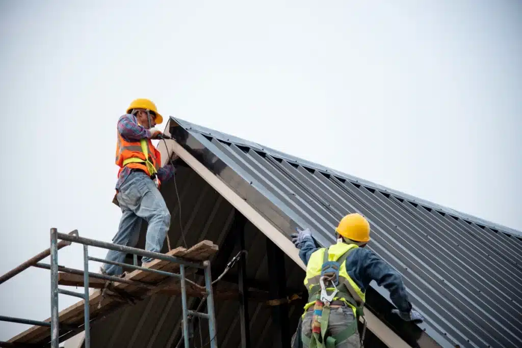 professional roofers installing metal roof