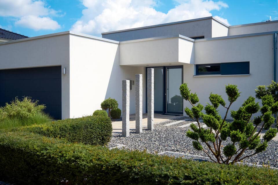 single ply membrane roof-white modern house with flat roof