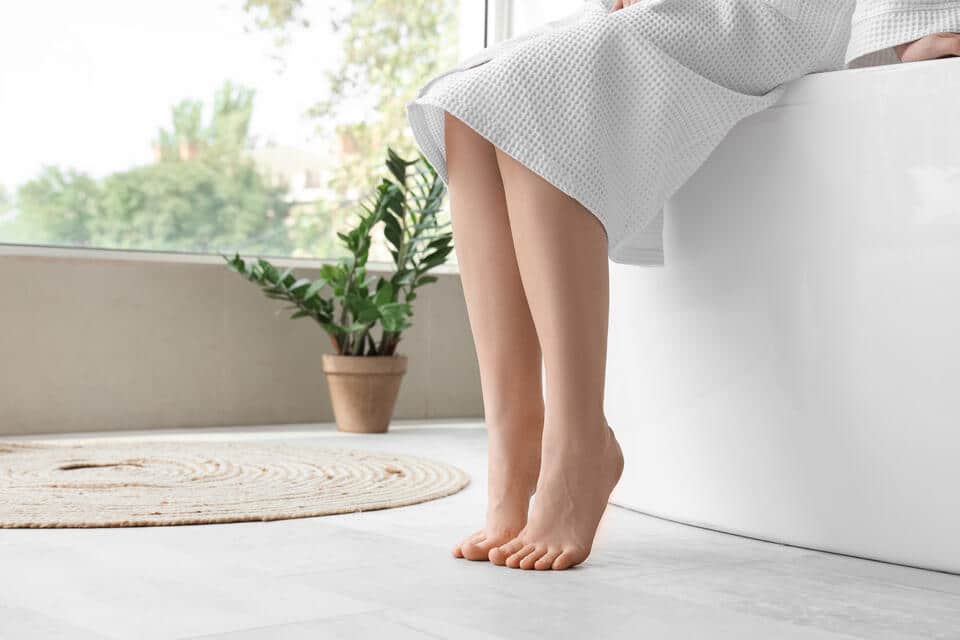 bathroom flooring options-womans feet on white bathroom flooring