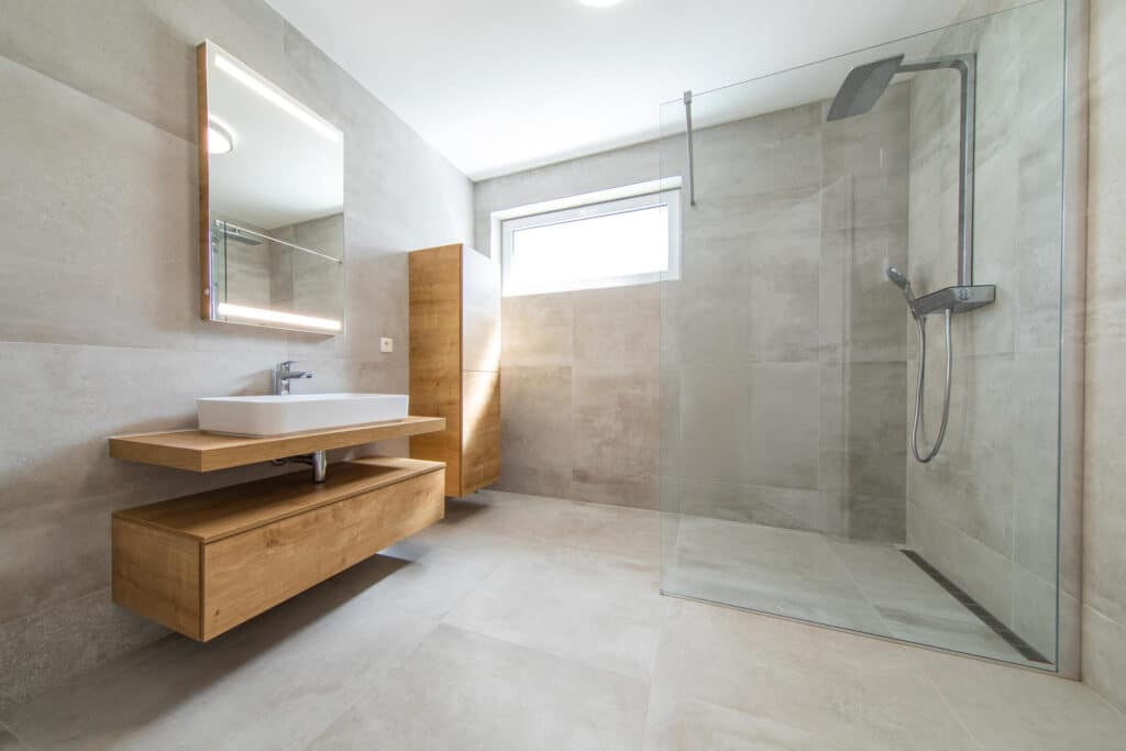 bathroom remodeling-large modern bathroom with pedestal sink and tiling on walls and flooring