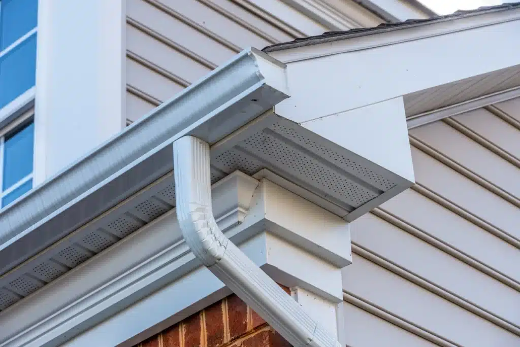 eaves of a house-white eaves against cream colored siding