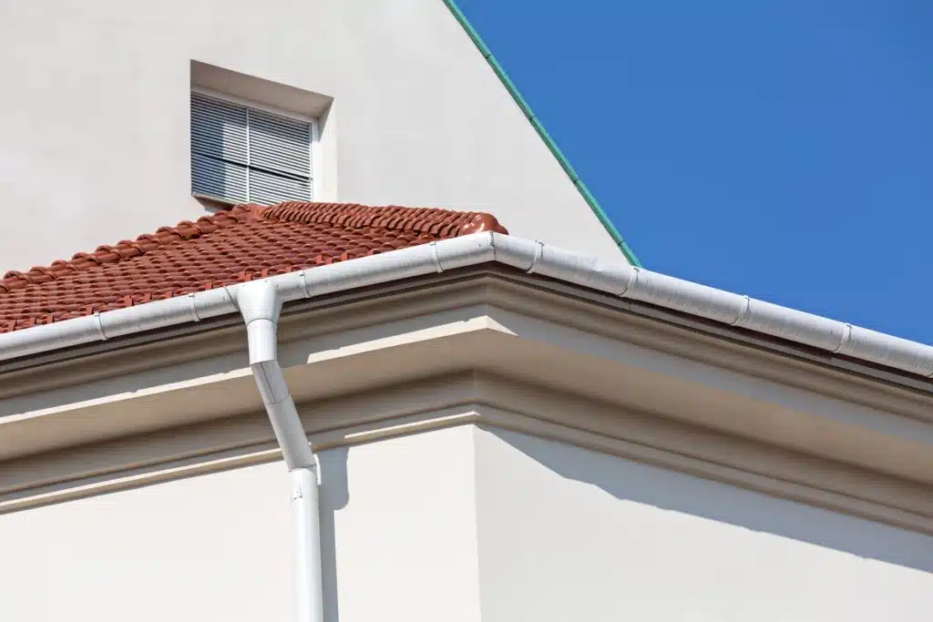 eaves of a house-white eaves on white house with clay tile roof